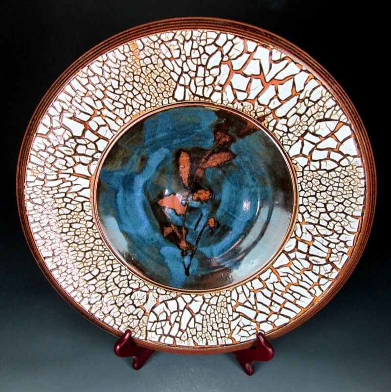 Porcelain plate with slip pattern and celadon glaze
