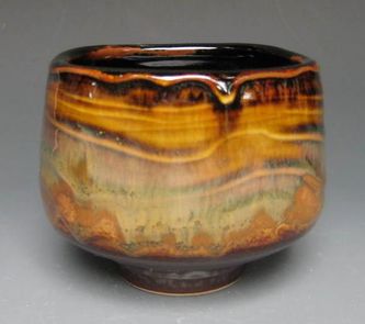 teabowl with slip pattern and temmoku and rutile glazes