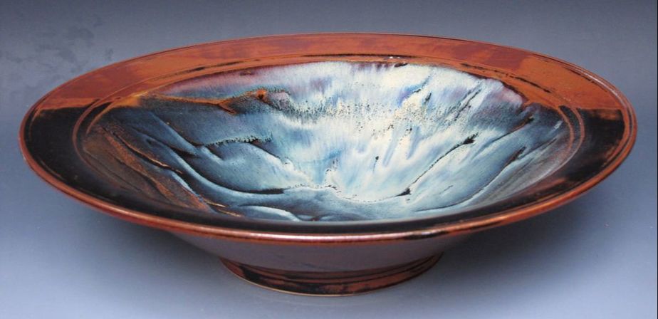 Porcelain bowl with temmoku, rutile, and satin cream glazes